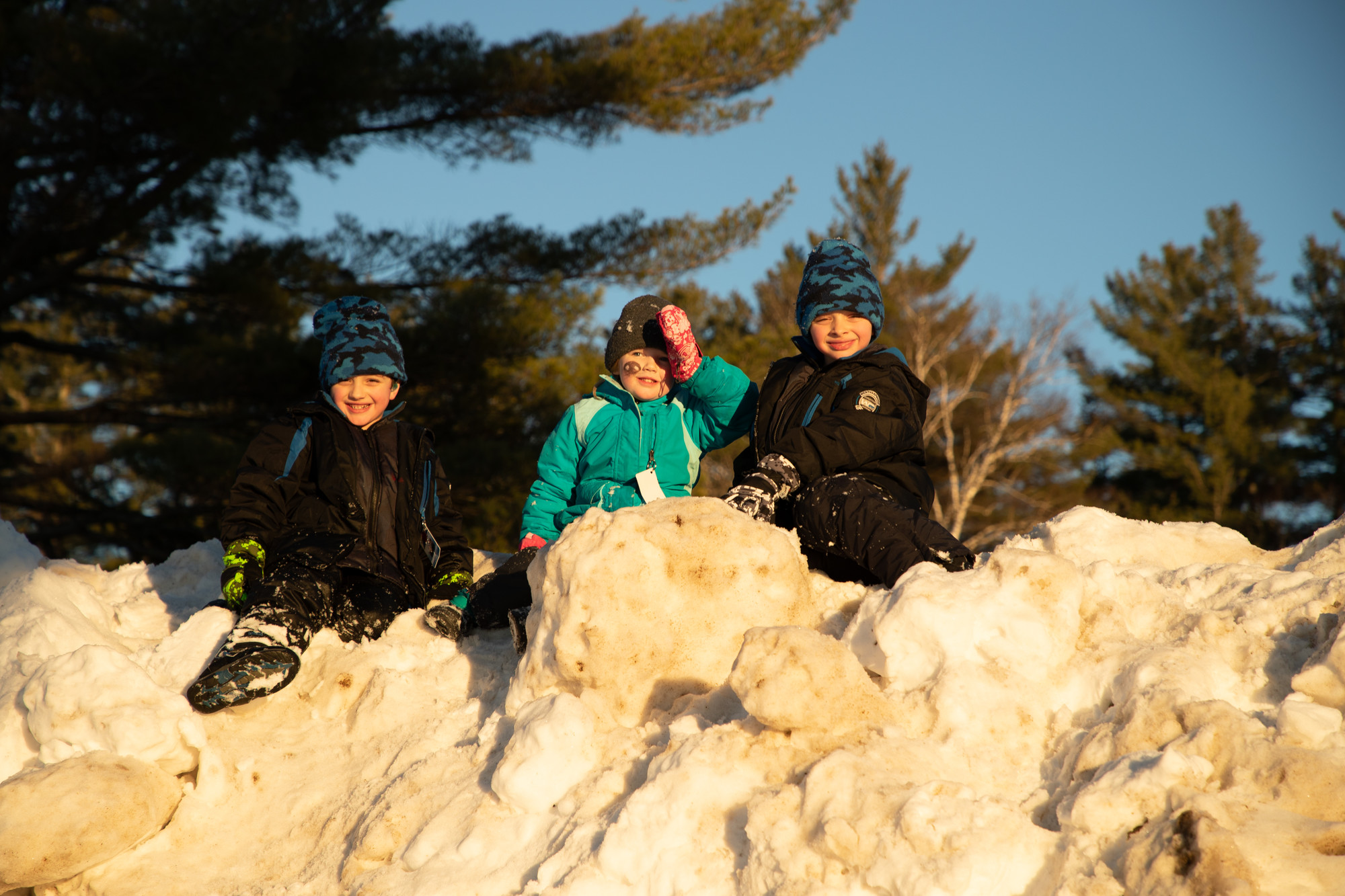 kids playing on snowbank in inlet ny 